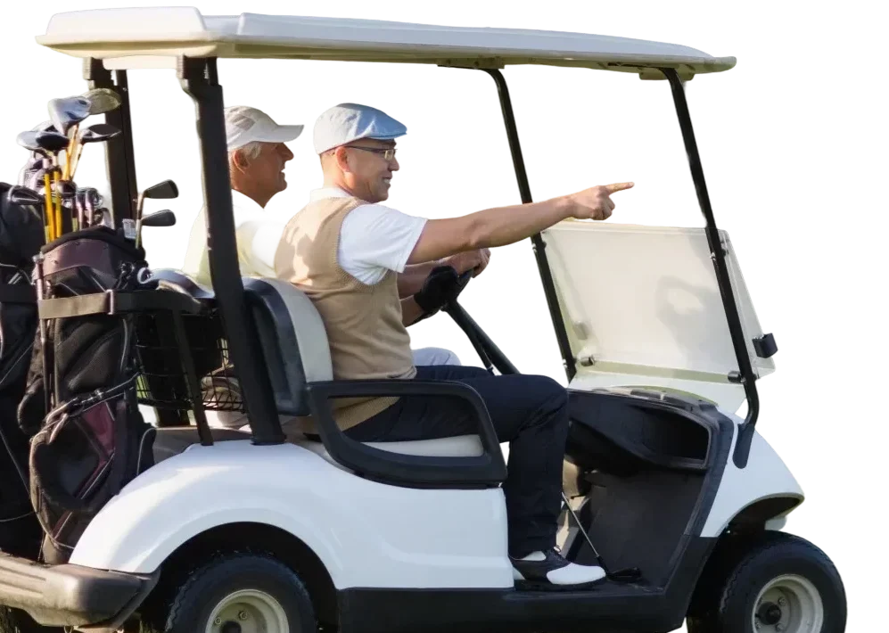 Two golfers in a golf cart with clubs, with the driver pointing ahead.